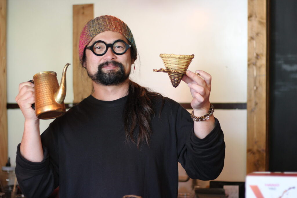 ひげのコーヒー西野智史氏。須賀川竹細工のコーヒードリッパーを手に。